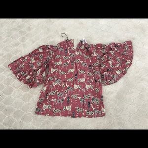 Pull over blouse with ruffled bell sleeves.